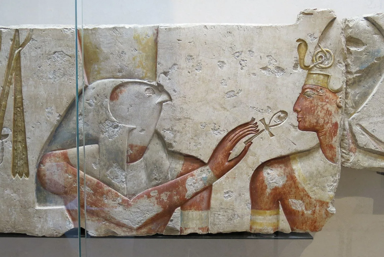 Horus offering the Ankh symbol, also known as the Egyptian cross, to the king