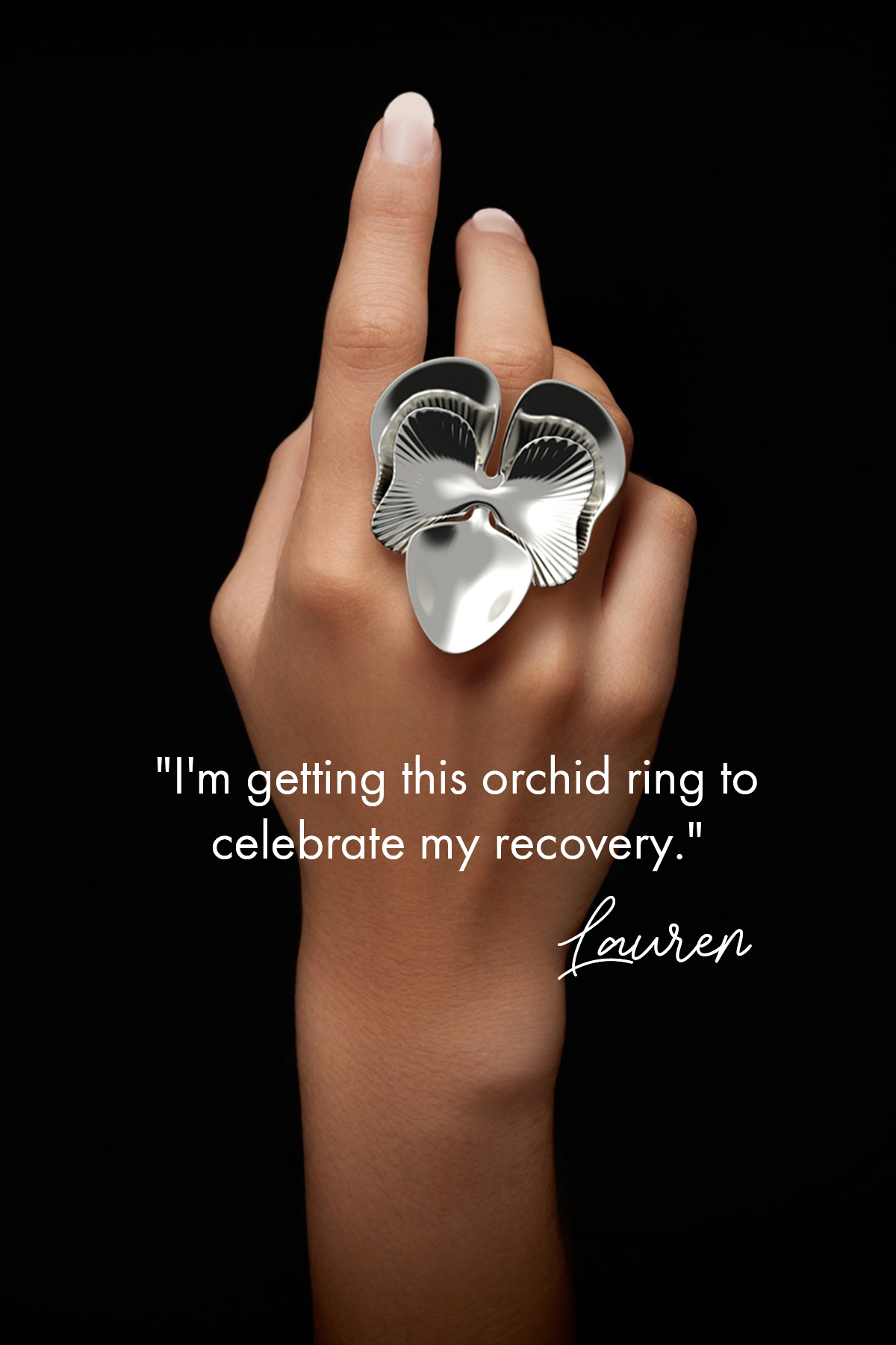 Close-up of a hand displaying a large sterling silver orchid ring against a dark background. The caption reads: 'I'm getting this orchid ring to celebrate my recovery.' signed by Lauren.