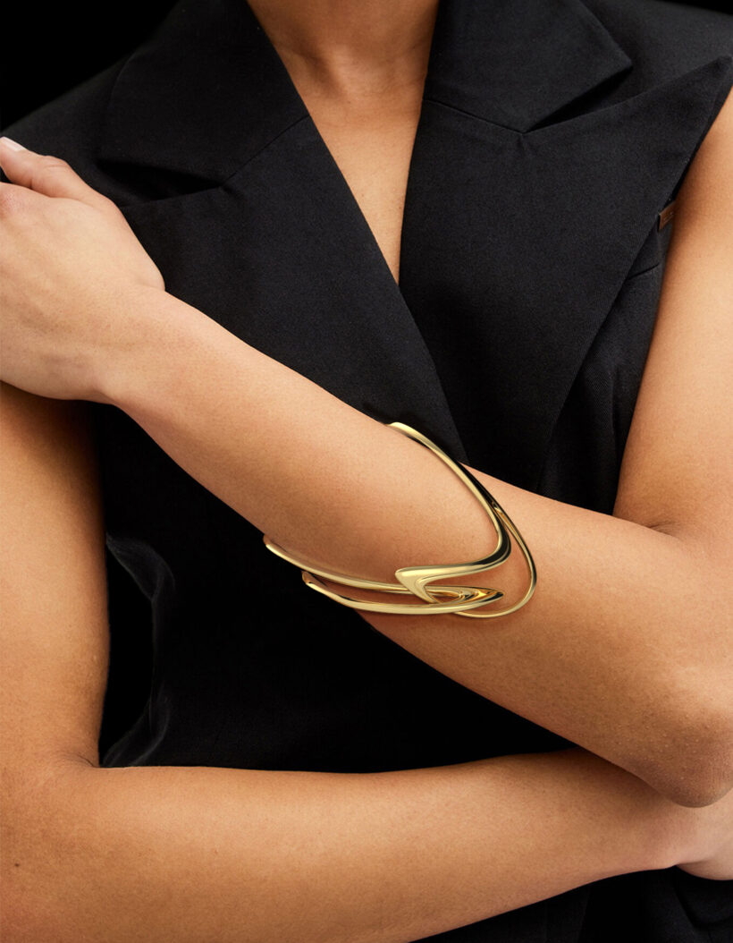 Gold Fluidity bracelet by Floa Design worn on arm