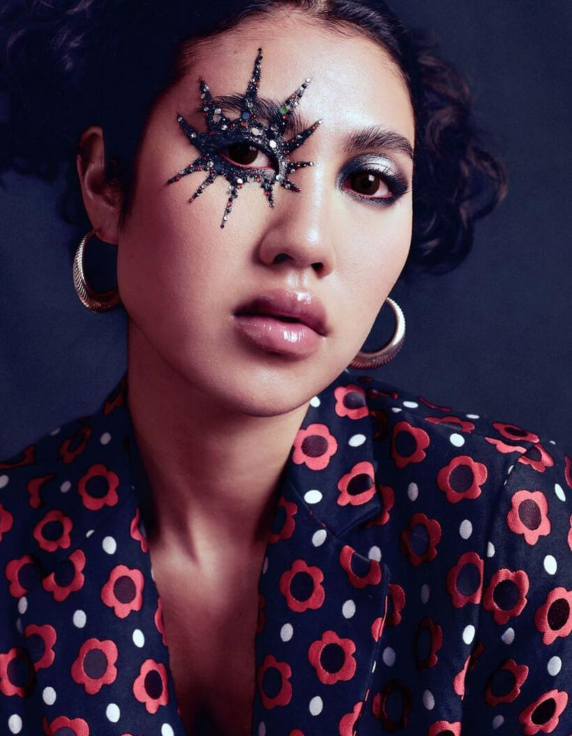 Model wearing Floa Design’s ribbed sterling silver horn hoop earrings with star-like makeup, floral jacket, in a beauty editorial for PAP Magazine's October cover.