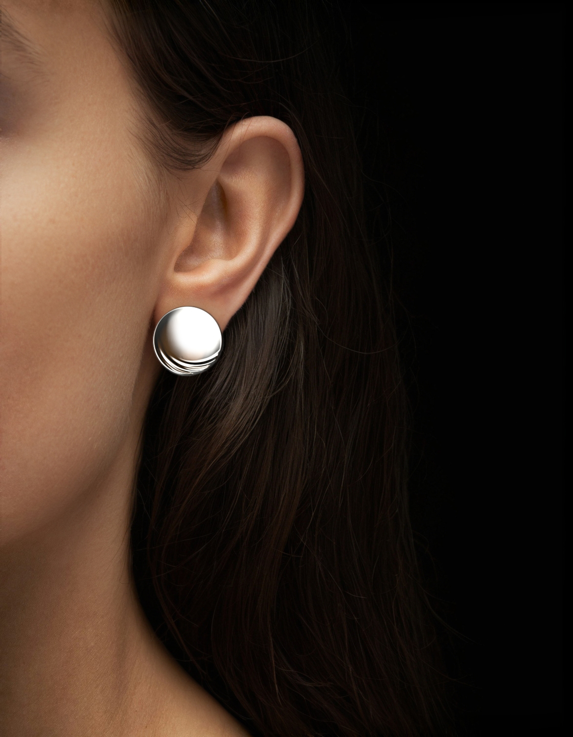 Luxury disc earrings in silver on womens ear by Floa Design Luxury disc earrings in silver on womens ear by Floa Design