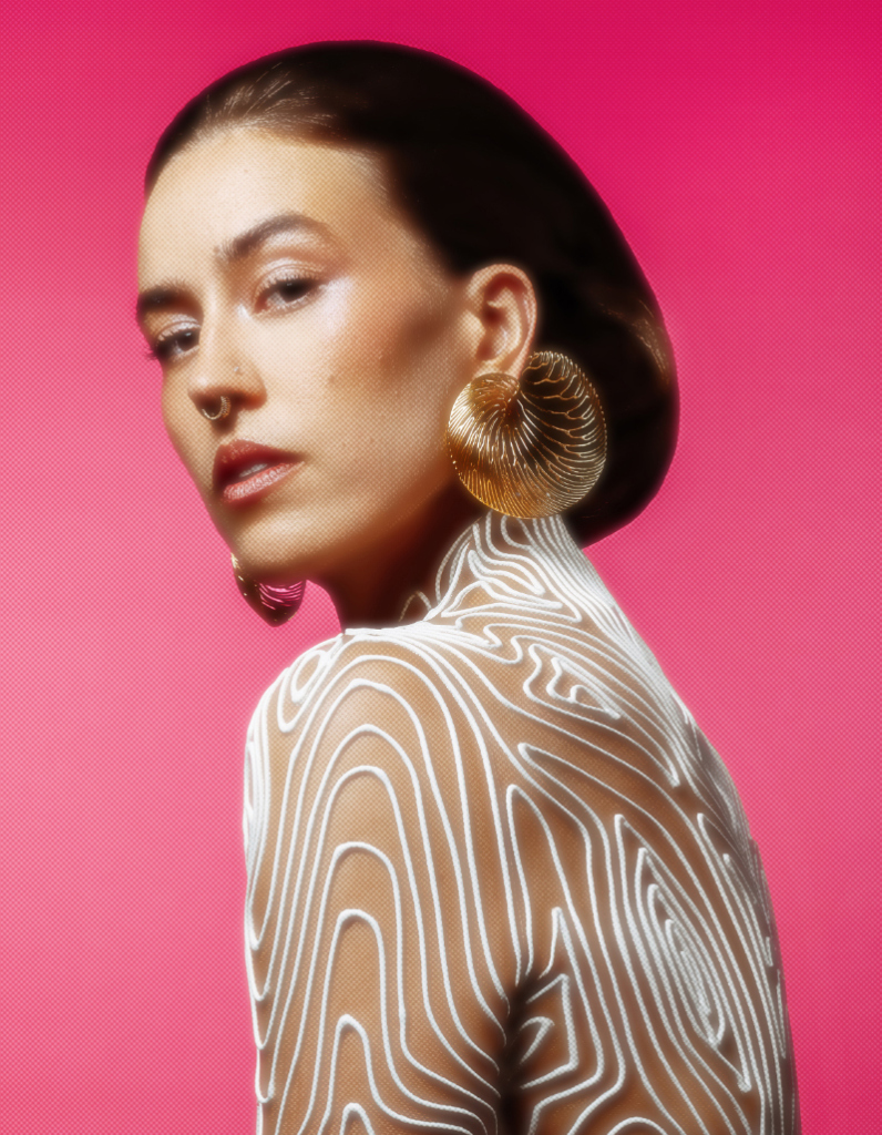 Big contemporary gold earrings featuring striated, undulating design by Floa Design worn by singer Evgenya Redko