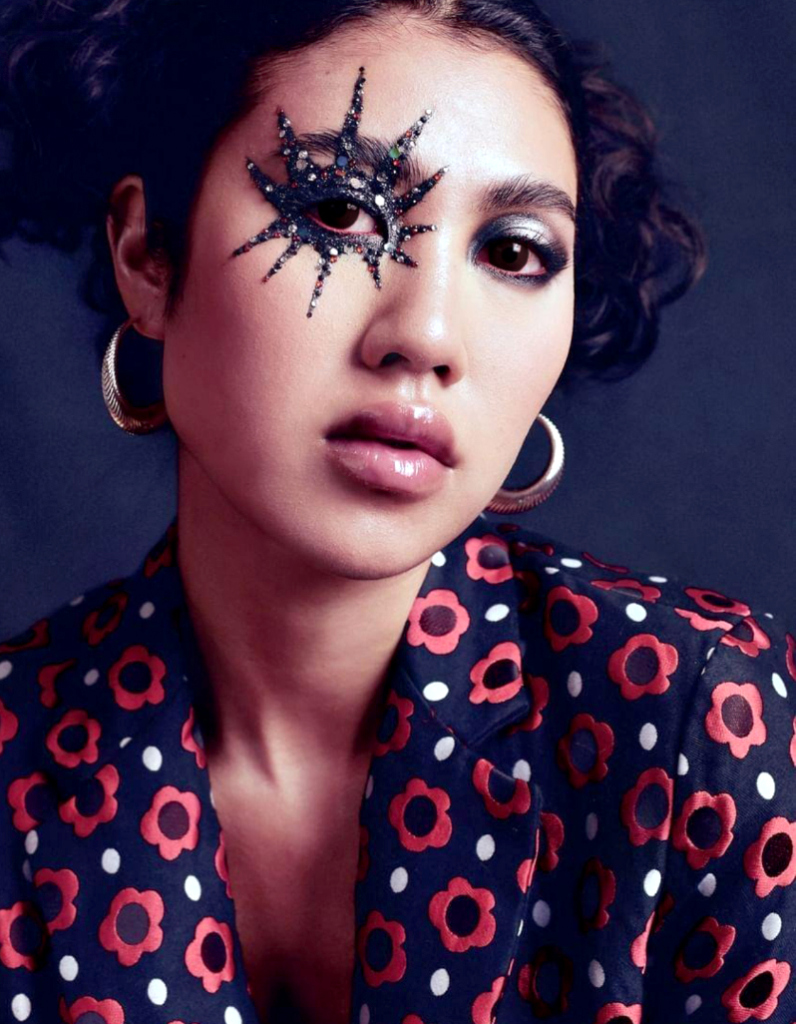 Model wearing large contemporary silver hoop earrings by Floa Design with dramatic makeup as seen in international avant-garde fashion magazine PAP.
