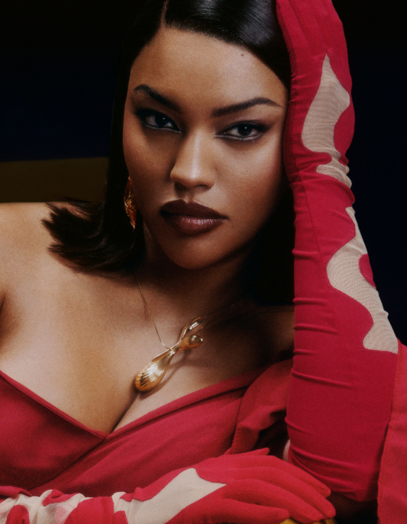 Celebrity Aziliz Zara wearing a luxurious contemporary jewellery set in gold featuring the seamless fish necklace pendant and seashell drop earrings by Floa Design for a glamorous photoshoot in Paris, France.